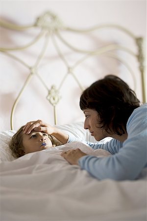 simsearch:632-03424324,k - High angle view of a mother checking her daughter's temperature Stock Photo - Premium Royalty-Free, Code: 640-01349494
