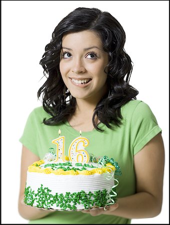 Close-up of a teenage girl holding a birthday cake Stock Photo - Premium Royalty-Free, Code: 640-01349529