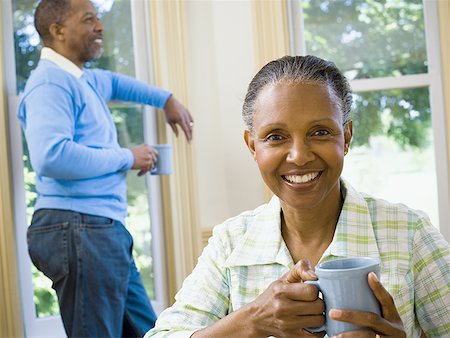 simsearch:640-02767388,k - Close-up of a senior woman holding a cup of coffee with a senior man standing behind her Stock Photo - Premium Royalty-Free, Code: 640-01349537