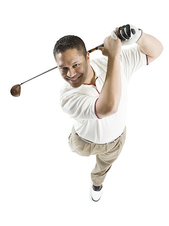 High angle view of a mid adult man swinging a golf club Stock Photo - Premium Royalty-Free, Code: 640-01349750