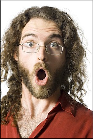 Surprised man with long hair and beard Stock Photo - Premium Royalty-Free, Code: 640-01349819