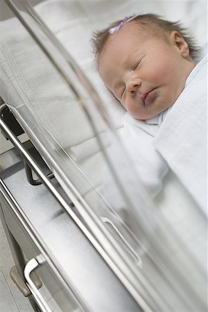 High angle view of a baby boy lying in a hospital nursery Stock Photo - Premium Royalty-Free, Code: 640-01349929