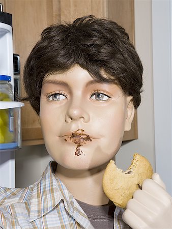 Close-up of a male mannequin holding a cookie Stock Photo - Premium Royalty-Free, Code: 640-01349992