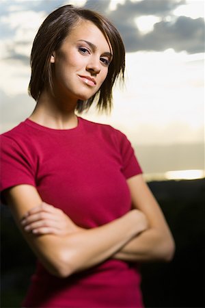 Portrait of a young woman standing with her arms crossed Stock Photo - Premium Royalty-Free, Code: 640-01354048