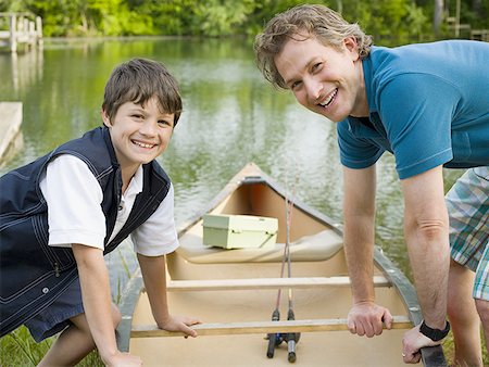 side view of person rowing in boat - Portrait of a man and his son bending forward over a canoe Stock Photo - Premium Royalty-Free, Code: 640-01354250
