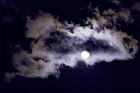 dark moon with clouds - Low angle view of a full moon overshadowed by a storm cloud Stock Photo - Premium Royalty-Free, Code: 640-01354319