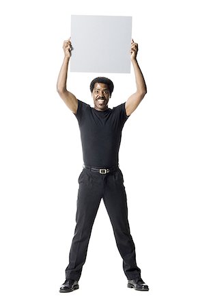 simsearch:640-02767716,k - A man smiling and holding a blank sign Stock Photo - Premium Royalty-Free, Code: 640-01354339