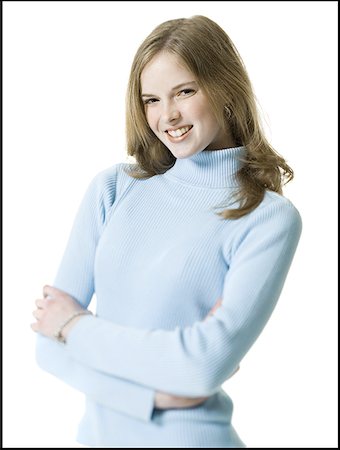 Portrait of a young woman smiling with her arms folded Stock Photo - Premium Royalty-Free, Code: 640-01354561