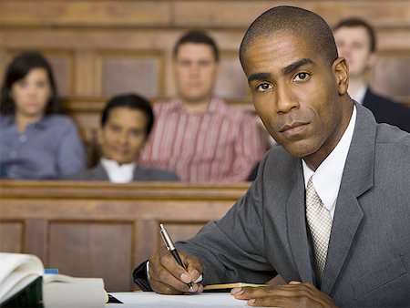 simsearch:640-01351636,k - Portrait of a male lawyer sitting in a courtroom Foto de stock - Sin royalties Premium, Código: 640-01354633