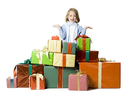 Portrait of a girl standing behind a stack of gifts Stock Photo - Premium Royalty-Free, Code: 640-01354750