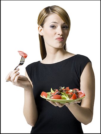 fashion plate - Portrait of a young woman eating a salad Stock Photo - Premium Royalty-Free, Code: 640-01354833