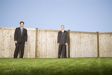 simsearch:640-01357365,k - Low angle view of two businessmen standing in front of a fence Stock Photo - Premium Royalty-Free, Code: 640-01354991