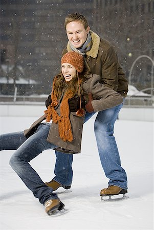 Couple falling while ice skating Stock Photo - Premium Royalty-Free, Code: 640-01354993