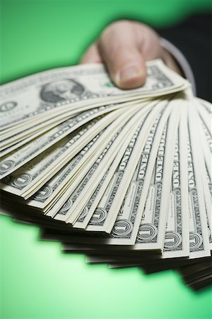 Close-up of a person's hand holding paper currency Stock Photo - Premium Royalty-Free, Code: 640-01355030