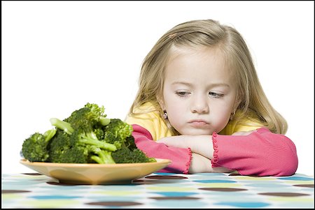 sad girls - Close-up of a girl looking at broccoli Stock Photo - Premium Royalty-Free, Code: 640-01355178