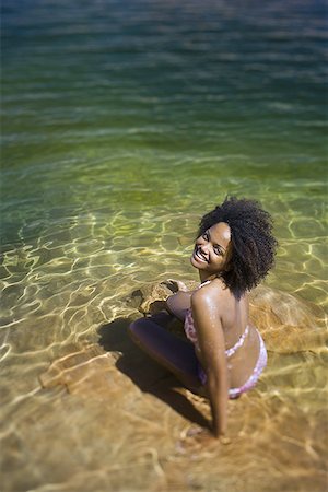 simsearch:640-01358229,k - Young woman sitting in water at the edge of a lake Stock Photo - Premium Royalty-Free, Code: 640-01355405