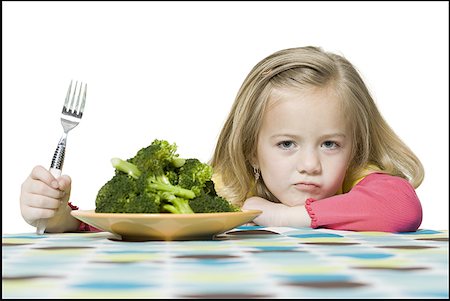 simsearch:640-01354413,k - Portrait of a girl sitting in front of a plate of broccoli Foto de stock - Sin royalties Premium, Código: 640-01355436