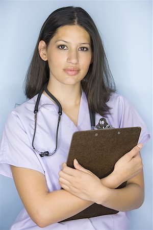 simsearch:640-01364042,k - Portrait of a female nurse holding a clipboard Stock Photo - Premium Royalty-Free, Code: 640-01355430