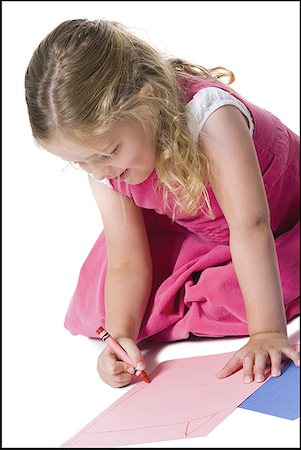 Close-up of a girl drawing on a sheet of paper Stock Photo - Premium Royalty-Free, Code: 640-01355432