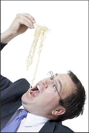 simsearch:640-01350815,k - Close-up of a young man eating noodles with chopsticks Stock Photo - Premium Royalty-Free, Code: 640-01355628