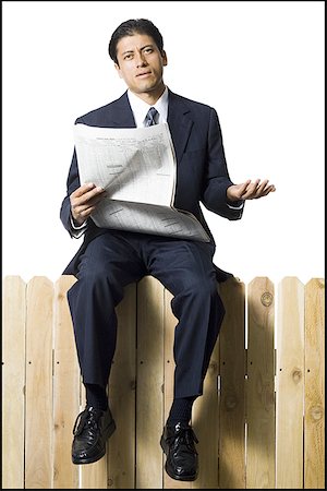 query - Businessman sitting on fence with newspaper Stock Photo - Premium Royalty-Free, Code: 640-01355924