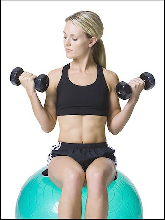 Young woman exercising with dumbbells Stock Photo - Premium Royalty-Free, Code: 640-01355937