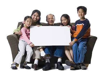 simsearch:640-01365707,k - Portrait of a family holding a blank sign and smiling Stock Photo - Premium Royalty-Free, Code: 640-01355954