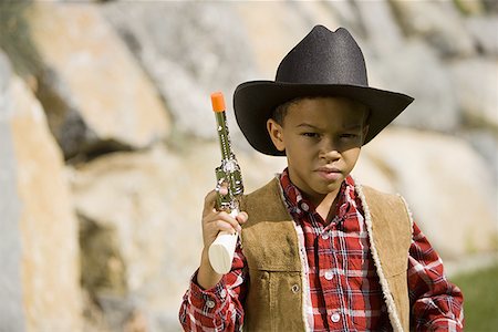 simsearch:695-03376367,k - Portrait of a boy in a cowboy costume holding a toy gun Stock Photo - Premium Royalty-Free, Code: 640-01356252