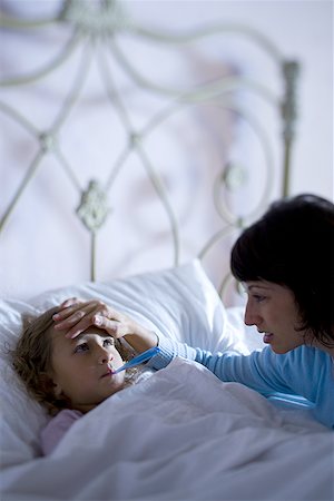 simsearch:6108-06907900,k - High angle view of a mother checking her daughter's temperature Stock Photo - Premium Royalty-Free, Code: 640-01356392