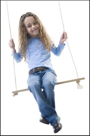 Portrait of a girl sitting on a swing Stock Photo - Premium Royalty-Free, Code: 640-01356718