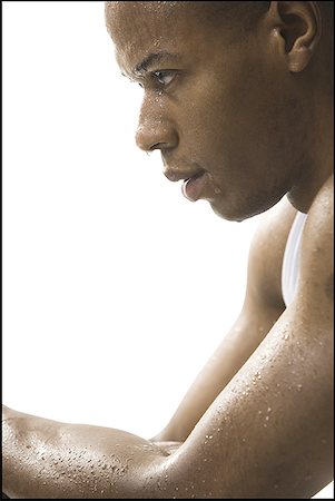 Close-up of a young man covered in sweat Stock Photo - Premium Royalty-Free, Code: 640-01356778
