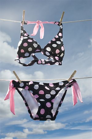 swimsuits not on people - Low angle view of a bikini hanging on a clothesline Stock Photo - Premium Royalty-Free, Code: 640-01356848