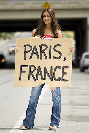 drifter - Woman hitchhiking a ride to Paris Stock Photo - Premium Royalty-Free, Code: 640-01356843