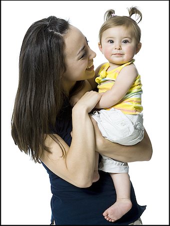 Close-up of a young woman carrying her daughter Stock Photo - Premium Royalty-Free, Code: 640-01356965