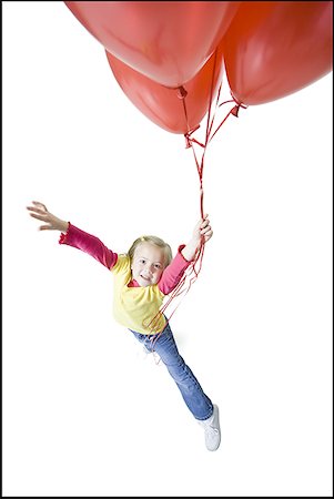 High angle view of a girl holding balloons Stock Photo - Premium Royalty-Free, Code: 640-01357013