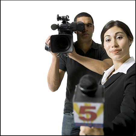 Female journalist with microphone and male videographer Stock Photo - Premium Royalty-Free, Code: 640-01357085