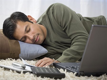 shag carpet - Close-up of a man sleeping next to his laptop Stock Photo - Premium Royalty-Free, Code: 640-01357111