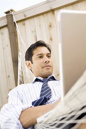 Low angle view of a businessman using a laptop Stock Photo - Premium Royalty-Free, Code: 640-01357268