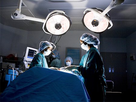 Female nurse and surgeon in scrubs during surgery Stock Photo - Premium Royalty-Free, Code: 640-01357490