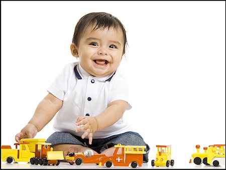 Baby boy playing with toy train Stock Photo - Premium Royalty-Free, Code: 640-01357493