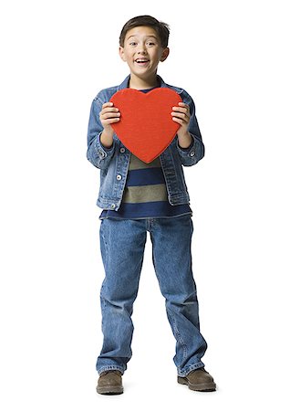 Portrait of a boy holding a heart Stock Photo - Premium Royalty-Free, Code: 640-01357519
