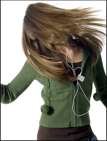 Girl with mp3 player dancing Stock Photo - Premium Royalty-Free, Code: 640-01357647