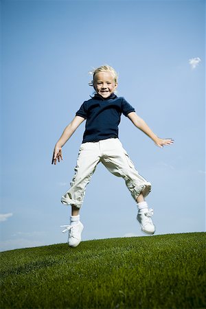 pantyhose kid - Low angle view of a girl jumping and smiling Stock Photo - Premium Royalty-Free, Code: 640-01357707