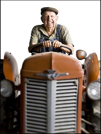 farmer and equipment - Farmer posing with his tractor Stock Photo - Premium Royalty-Free, Code: 640-01357748