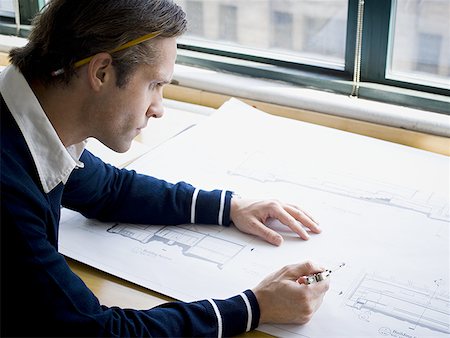 sketching - Profile of an architect working on a blueprint Stock Photo - Premium Royalty-Free, Code: 640-01357837