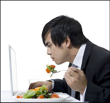 simsearch:640-01350815,k - Profile of a businessman eating and using a laptop Stock Photo - Premium Royalty-Free, Code: 640-01357961