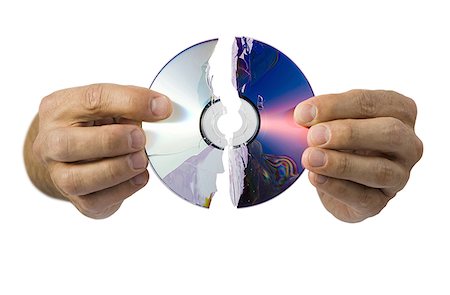 Close-up of a broken compact disk in a man's hand Stock Photo - Premium Royalty-Free, Code: 640-01358168