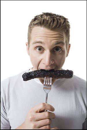 simsearch:640-01350815,k - Portrait of a young man eating a sausage Stock Photo - Premium Royalty-Free, Code: 640-01358185