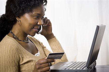 simsearch:640-02767388,k - Profile of a mature woman talking on a mobile phone and holding a credit card Stock Photo - Premium Royalty-Free, Code: 640-01358183