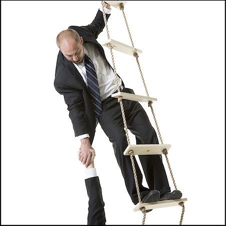 Close-up of a businessman helping a person climb a ladder Stock Photo - Premium Royalty-Free, Code: 640-01358219